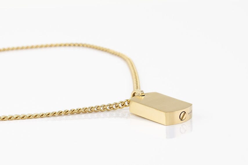 Gold dog tag pendant urn with gold necklace on a white background side view