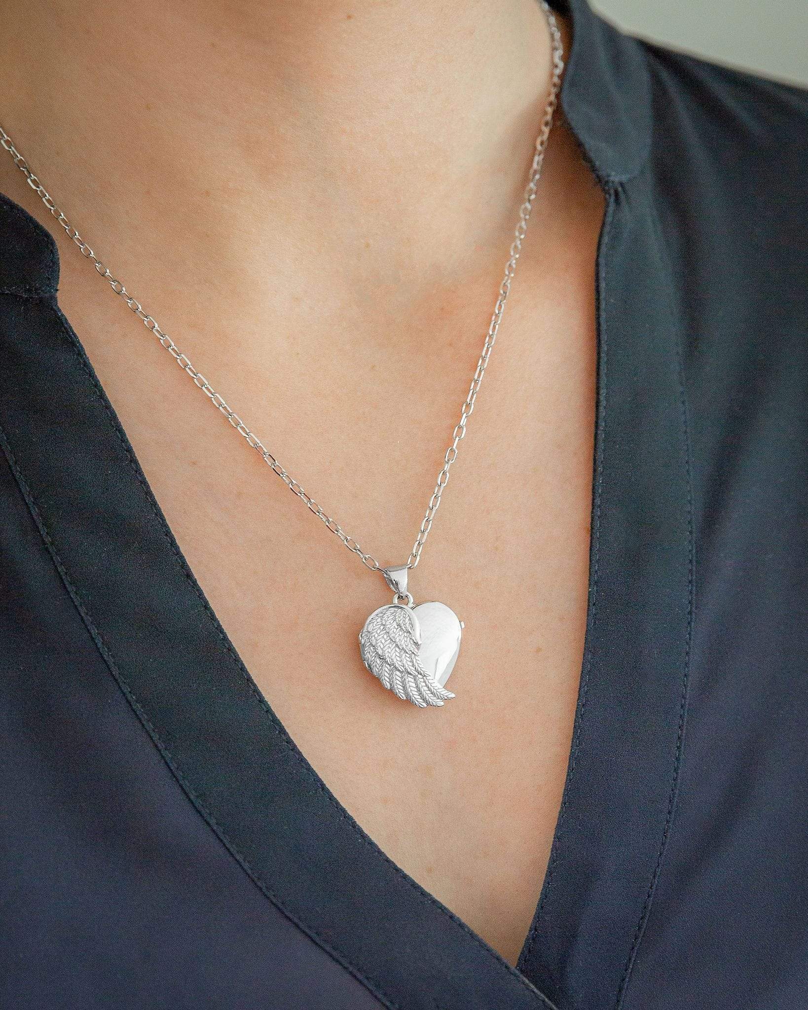 Cara Keepsakes Silver Locket Urns Silver Angel Wing Locket Urn worn on model