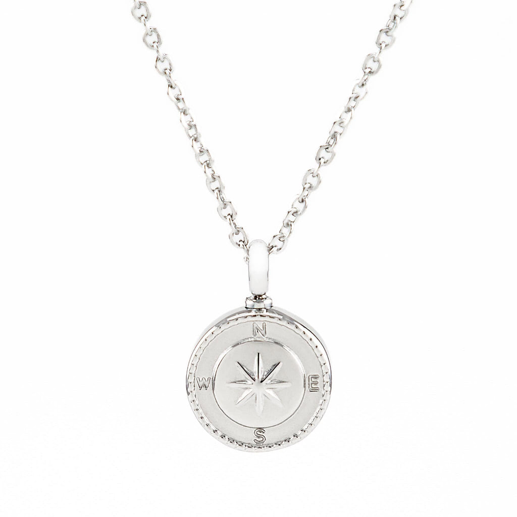 Silver urn necklace with a round compass pendant on a white background